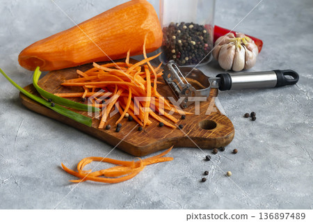 Ingredients for carrot and green onion salad. Vegetable cutting process. Ingredients for carrot and green onion salad. Vegetable cutting process. 136897489