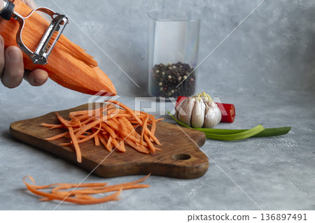 Ingredients for carrot and green onion salad. Vegetable cutting process. Ingredients for carrot and green onion salad. Vegetable cutting process. 136897491