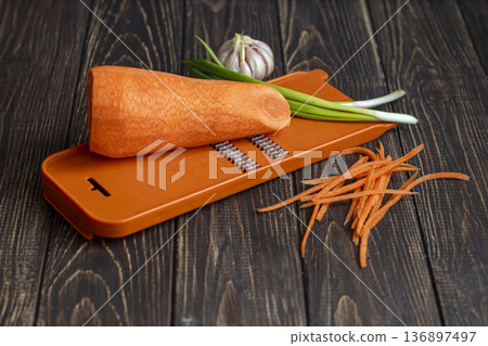 Ingredients for carrot and green onion salad. Vegetable cutting process. Ingredients for carrot and green onion salad. Vegetable cutting process. 136897497