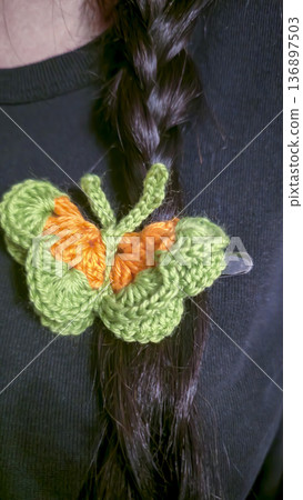 Butterflies made of colored yarn, crocheted on a dark surface. Handmade. 136897503