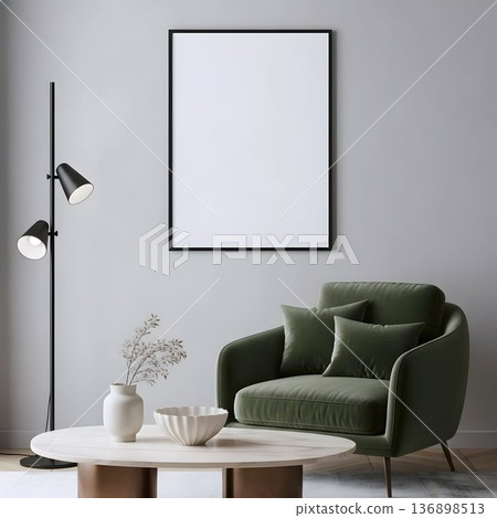 Modern green velvet armchair with empty black picture frame on wall in minimalist cozy living room interior with soft lighting 136898513