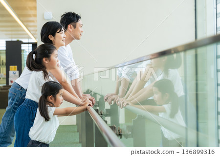 Family looking out from a building 136899316
