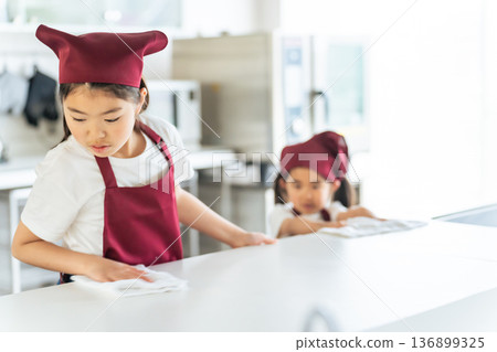 Kids cleaning the kitchen Kids cleaning the kitchen 136899325