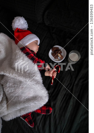 Sleeping Baby in Santa Hat with Cookies and Milk Sleeping Baby in Santa Hat with Cookies and Milk 136899483
