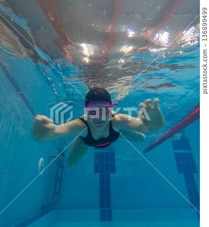 Underwater swimmer practicing freestyle in lap pool Underwater swimmer practicing freestyle in lap pool 136899499