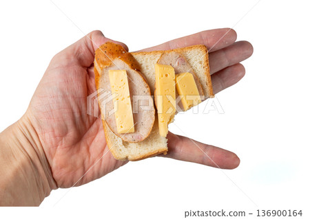 Sandwich in hand. The concept of malnutrition or unhealthy eating habits 136900164