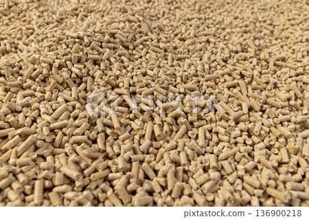 a large number of cylindrical fuel pellets made from sawdust of coniferous spruce or pine trees, the pellets are used both for bedding for pets, wood pellets 136900218