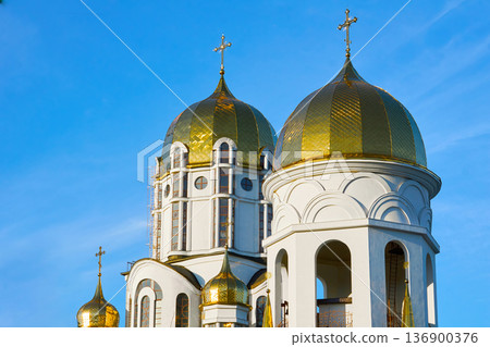 Easter.Majestic Christian church with golden domes, blue clear sky Easter.Majestic Christian church with golden domes, blue clear sky 136900376