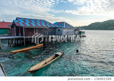 Fishermen houses and boats in Bajo village of Pulau Papan Sulawesi Indonesia Fishermen houses and boats in Bajo village of Pulau Papan Sulawesi Indonesia 136901589