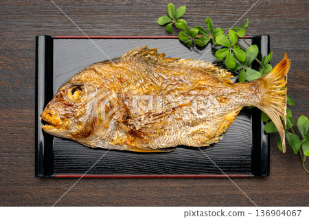 A celebratory Japanese meal topped with grilled whole sea bream 136904067