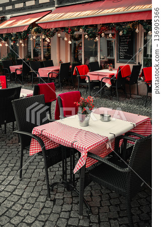 Cozy Outdoor Cafe Tables with Checkered Tablecloths Cozy Outdoor Cafe Tables with Checkered Tablecloths 136905366