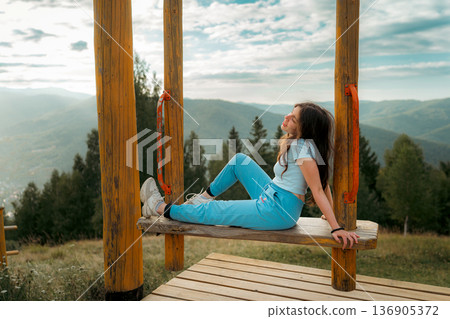 Woman Enjoying Mountain Landscape at Scenic Viewpoint Woman Enjoying Mountain Landscape at Scenic Viewpoint 136905372
