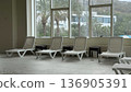 Plastic white sun longers near the indoor pool 136905391