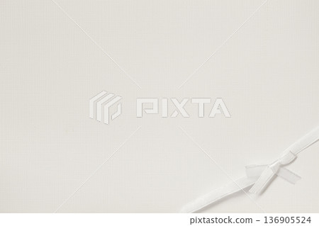 Paper background with ribbon bow placed on corner, wide copy space for card, invitation, mockup. Natural background, paper texture, stationery, greeting card layout 136905524