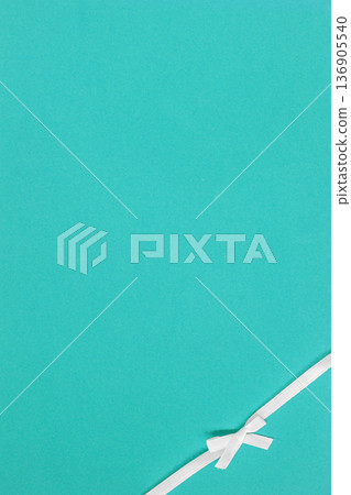 Transformative teal background, smooth teal surface, white ribbon bow in corner, elegant copy space. Concept of Transformative teal color trend, minimal design, gift presentation, modern branding Transformative teal background, smooth teal surface, white ribbon bow in corner, elegant copy space. Concept of Transformative teal color trend, minimal design, gift presentation, modern branding 136905540