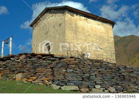 The old Orthodox church of Lamaria and its bell in the village of Ushguli, Georgia. 136905946