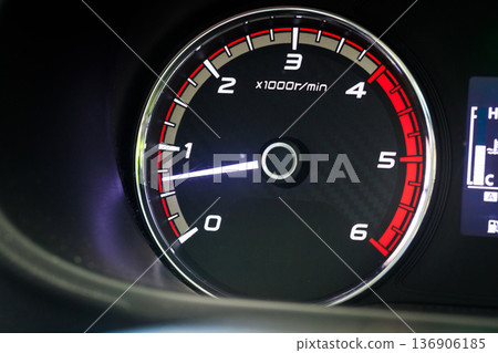 Close-up of a diesel truck's dashboard and tachometer. It represents the power and durability of a work vehicle, with a clear focus on the round engine meters. 136906185