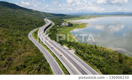 Drone shot The M6 motorway Nakhon Ratchasima Province - Bang Pa-in Lam Ta Khong River and Mountain. Motorway Korat Thailand Drone shot The M6 motorway Nakhon Ratchasima Province - Bang Pa-in Lam Ta Khong River and Mountain. Motorway Korat Thailand 136906250