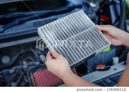 Hand of Woman Holding Dirty Cabin Air Filter Hand of Woman Holding Dirty Cabin Air Filter 136906518
