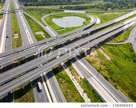 Drone shot a large highway interchange crossing over green farmlands in Thailand Drone shot a large highway interchange crossing over green farmlands in Thailand 136906643