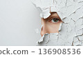 Eye gazing through a cracked white wall, symbolizing curiosity and discovery. 136908536