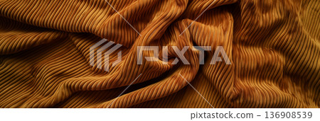 Luxurious golden fabric with dynamic waves and folds, capturing the soft texture and sheen across its surface. Luxurious golden fabric with dynamic waves and folds, capturing the soft texture and sheen across its surface. 136908539