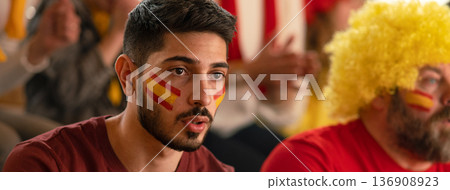 Nervous football fans supproting spanish national team in live soccer match at stadium. Nervous football fans supproting spanish national team in live soccer match at stadium. 136908923