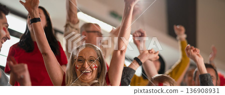Excited football fans supproting English national team in live soccer match at stadium. Excited football fans supproting English national team in live soccer match at stadium. 136908931
