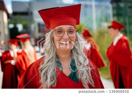 Senior woman student outdoors, graduation and third age university concept. Senior woman student outdoors, graduation and third age university concept. 136908938
