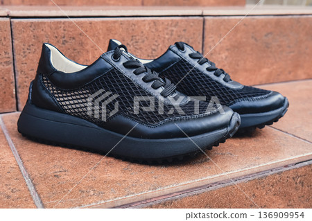Elegant black leather womens shoes blank product for branding displayed. New casual female sneakers no-brand footwear e-commerce. No logo product Elegant black leather womens shoes blank product for branding displayed. New casual female sneakers no-brand footwear e-commerce. No logo product 136909954
