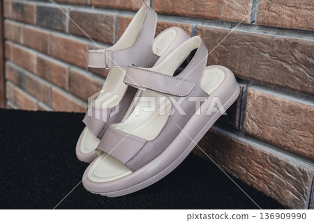 Elegant beige leather women sandals blank product for summer fashion branding and premium product showcases. Modern casual design and soft leather texture retail, e-commerce catalogs. No-brand Elegant beige leather women sandals blank product for summer fashion branding and premium product showcases. Modern casual design and soft leather texture retail, e-commerce catalogs. No-brand 136909990