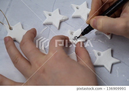 Christmas star with word HOPE Master class writing word HOPE Unrecognizable artist do it yourself air dry clay crafts for Christmas tree decor holiday. Decoration gift idea Handmade children craft Christmas star with word HOPE Master class writing word HOPE Unrecognizable artist do it yourself air dry clay crafts for Christmas tree decor holiday. Decoration gift idea Handmade children craft 136909991