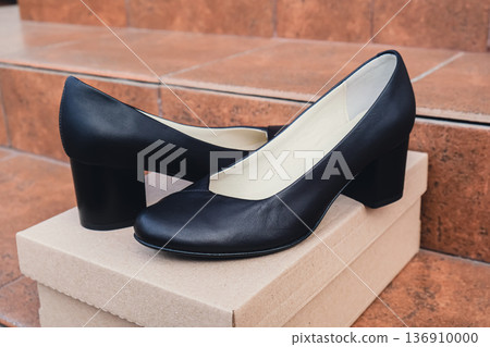 Elegant black leather womens shoes displayed. New black leather female shoes with glossy finish, perfect for style magazines footwear ads and modern elegant fashion e-commerce layouts. No logo 136910000