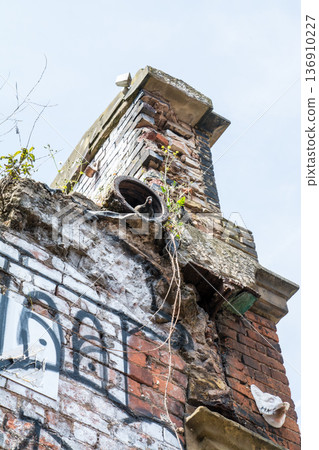 A street lined with historic brick buildings under bright sunlight in Shoreditch, East London 136910227