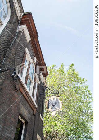 A street lined with historic brick buildings under bright sunlight in Shoreditch, East London A street lined with historic brick buildings under bright sunlight in Shoreditch, East London 136910236