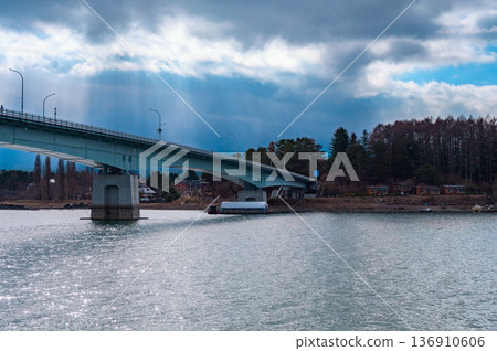 Mount Fuji and Lake Kawaguchiko Bridge hidden behind the Angel's Ladder [taken from a sightseeing boat] 136910606