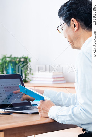 A middle-aged man checking his pension payment A middle-aged man checking his pension payment 136910866