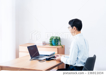 Hands of a man preparing to file his tax return 136911034