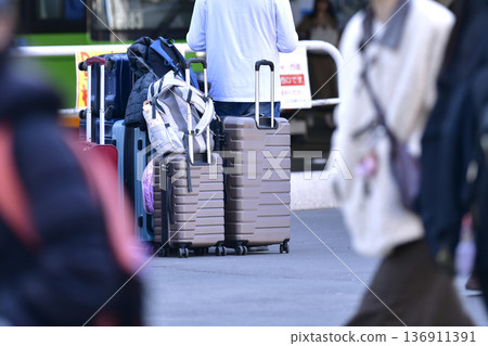 Tokyo cityscape in Japan Inbound tourism continues... suitcases... father keeps watch while mother and daughter leave their luggage and go somewhere = Shibuya 136911391