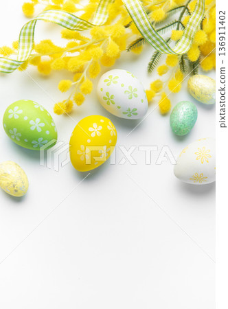 Easter eggs and mimosa creating spring holiday background Easter eggs and mimosa creating spring holiday background 136911402