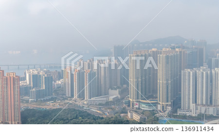 Hazy skyline of Tseung Kwan O overlooking dense highrises Feb 21 2026 136911434