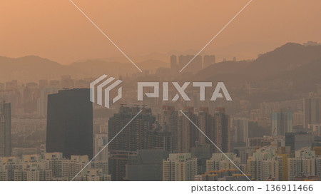 Hazy Kowloon skyline glowing under warm sunset Feb 19 2026 Hazy Kowloon skyline glowing under warm sunset Feb 19 2026 136911466