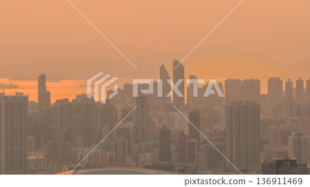 Warm sunset over hazy West Kowloon skyline Feb 19 2026 136911469