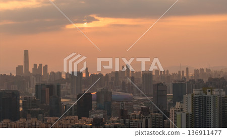 Hazy Kowloon skyline glowing under warm sunset Feb 19 2026 Hazy Kowloon skyline glowing under warm sunset Feb 19 2026 136911477