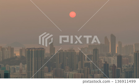 Warm sunset over hazy West Kowloon skyline Feb 19 2026 136911499