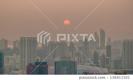 Hazy Kowloon skyline glowing under warm sunset Feb 19 2026 Hazy Kowloon skyline glowing under warm sunset Feb 19 2026 136911501