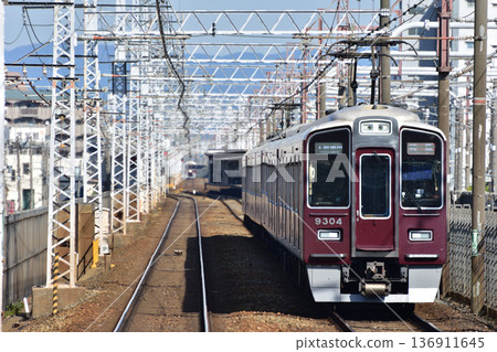 Hankyu Kyoto Line 9300 series train passing through Kamimaki Station Hankyu Kyoto Line 9300 series train passing through Kamimaki Station 136911645