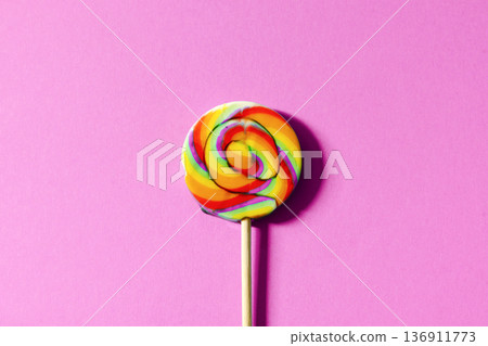 Swirl lollipop on a pink background colorful candy concept Swirl lollipop on a pink background colorful candy concept 136911773