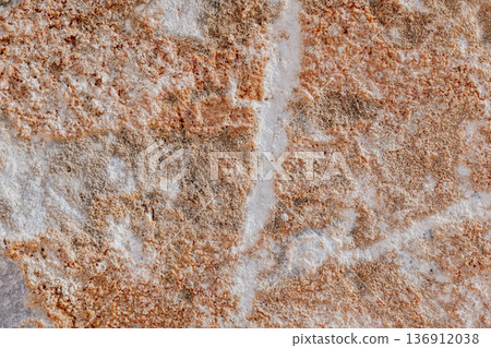Close-up of natural stone texture with coral and ginger orange tones. Rough rocky surface pattern Close-up of natural stone texture with coral and ginger orange tones. Rough rocky surface pattern 136912038