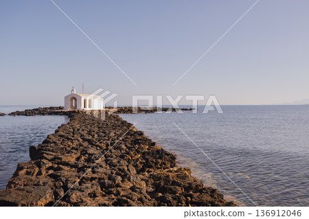 Coastal sentinel: the miniature stone church standing alone against the blue of the Mediterranean Coastal sentinel: the miniature stone church standing alone against the blue of the Mediterranean 136912046